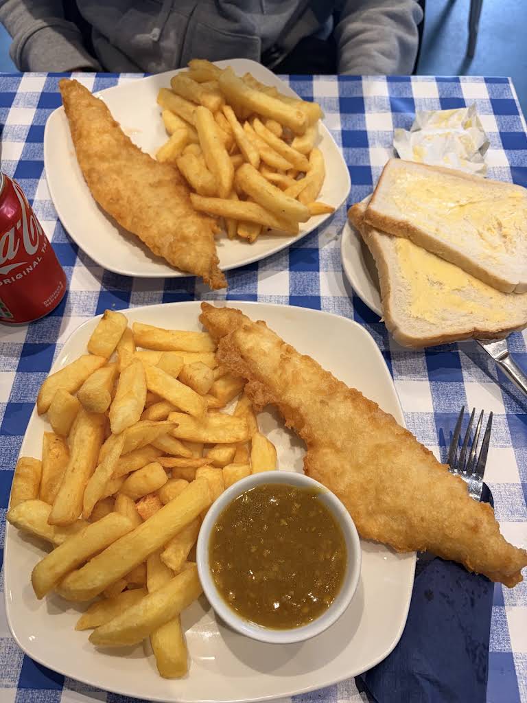 Fish and chips served at Bentley’s on its blue and white checked tablecloth.